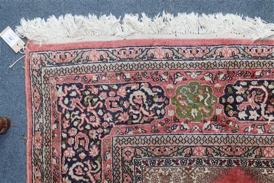 A Persian pattern rose ground cotton and silk rug 298 x 215cm